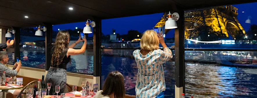 Taking pictures of the Eiffel Tower on a night cruise on the Seine