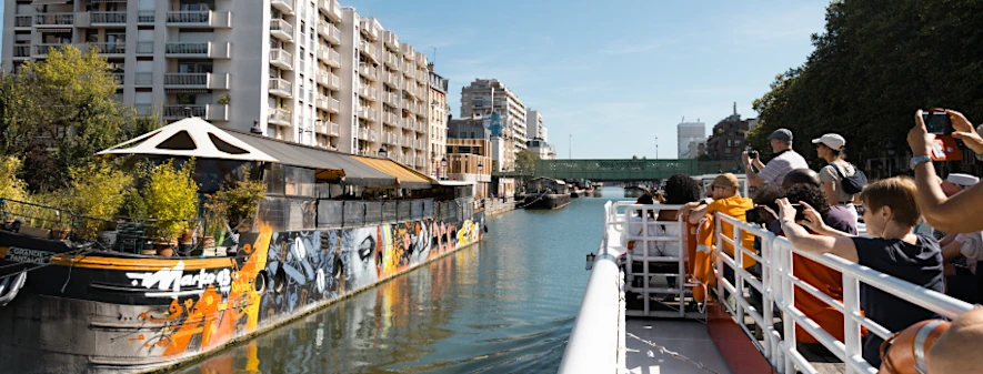 Taking pictures of street art on board a cruise on the Saint-Martin canal