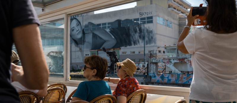 Giant mural of a woman, lying on her side, on a building along the Ourcq Canal